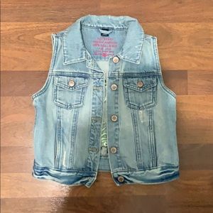 A jean jacket with designs on the back. Size M (8)